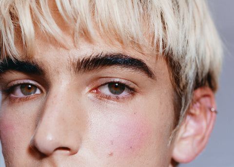 blonde african american man with blue eyes looking at camera
