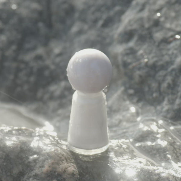 Video of Perfect Pearl polish bottle on a rock splashed by water